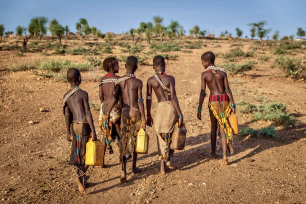 A group of young men walking across the desert.