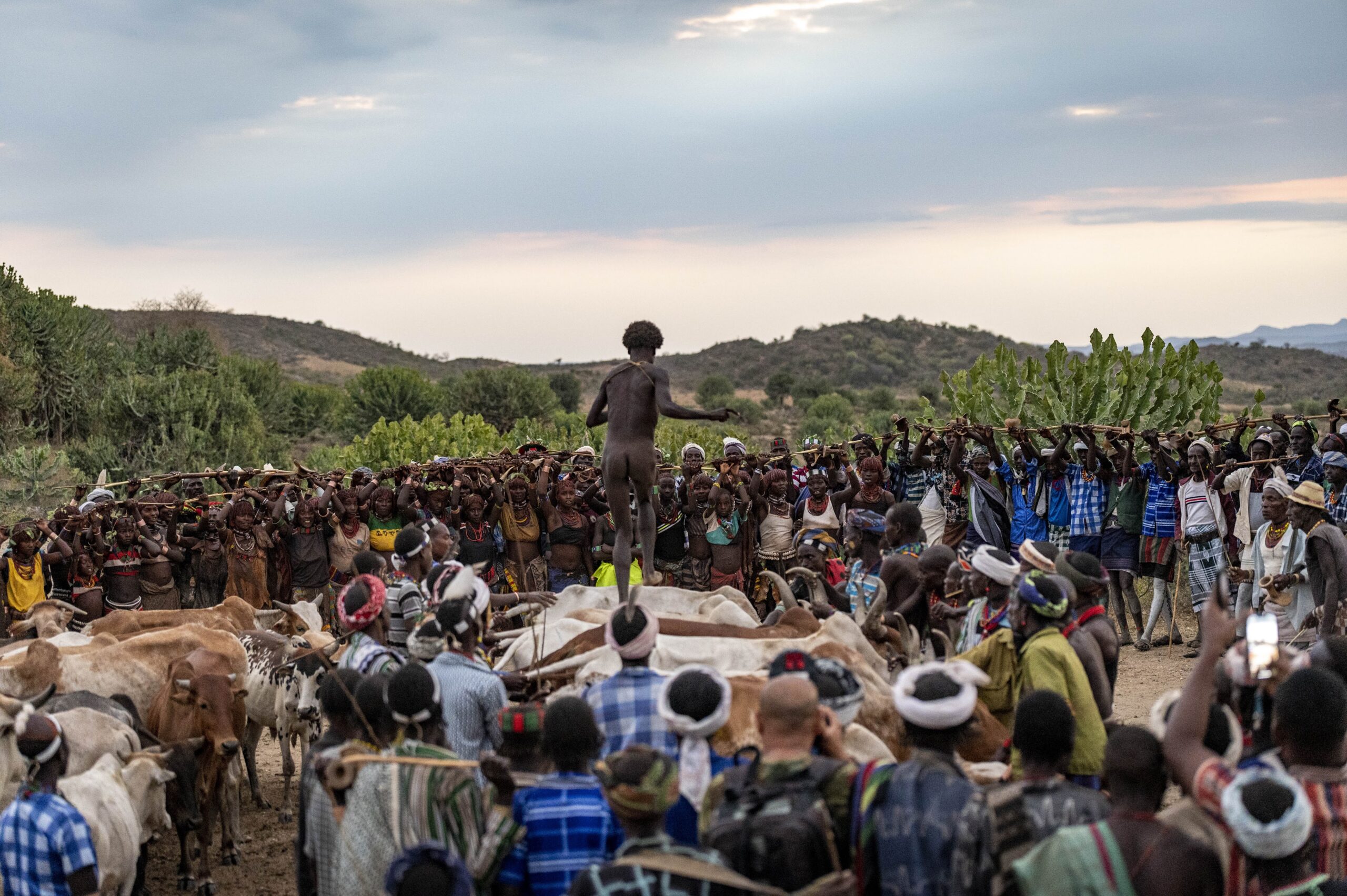 A man standing on top of a rock in front of a crowd.